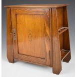Arts & Crafts oak smoker's cabinet with exterior pipe racks to the sides, fitted interior and