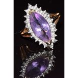 A 9ct gold ring set with a marquise cut amethyst surrounded by diamonds, 3.2g, size K