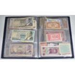 A collection of world banknotes in an album, includes AK47 £5, consecutive £1 pair etc