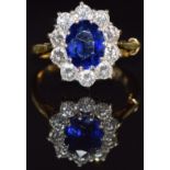 An 18ct gold ring set with an oval cut Ceylon sapphire of approximately 2.58ct surrounded by ten