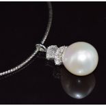 An 18ct white gold pendant set with a 23ct South Sea pearl, baguette and round cut diamonds, total