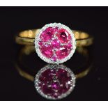 An 18ct gold ring set with rubies and diamonds in a cluster, 4.2g, size O