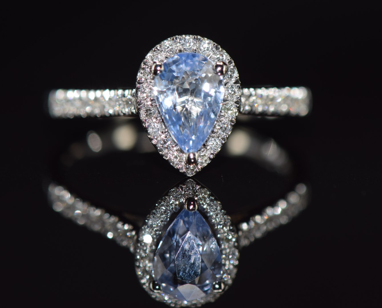 A platinum ring set with a pear cut Sri Lankan sapphire of approximately 1.25ct surrounded by