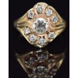 A 14k gold ring set with nine diamonds, the centre diamond approximately 0.7ct, 5.4g, size P