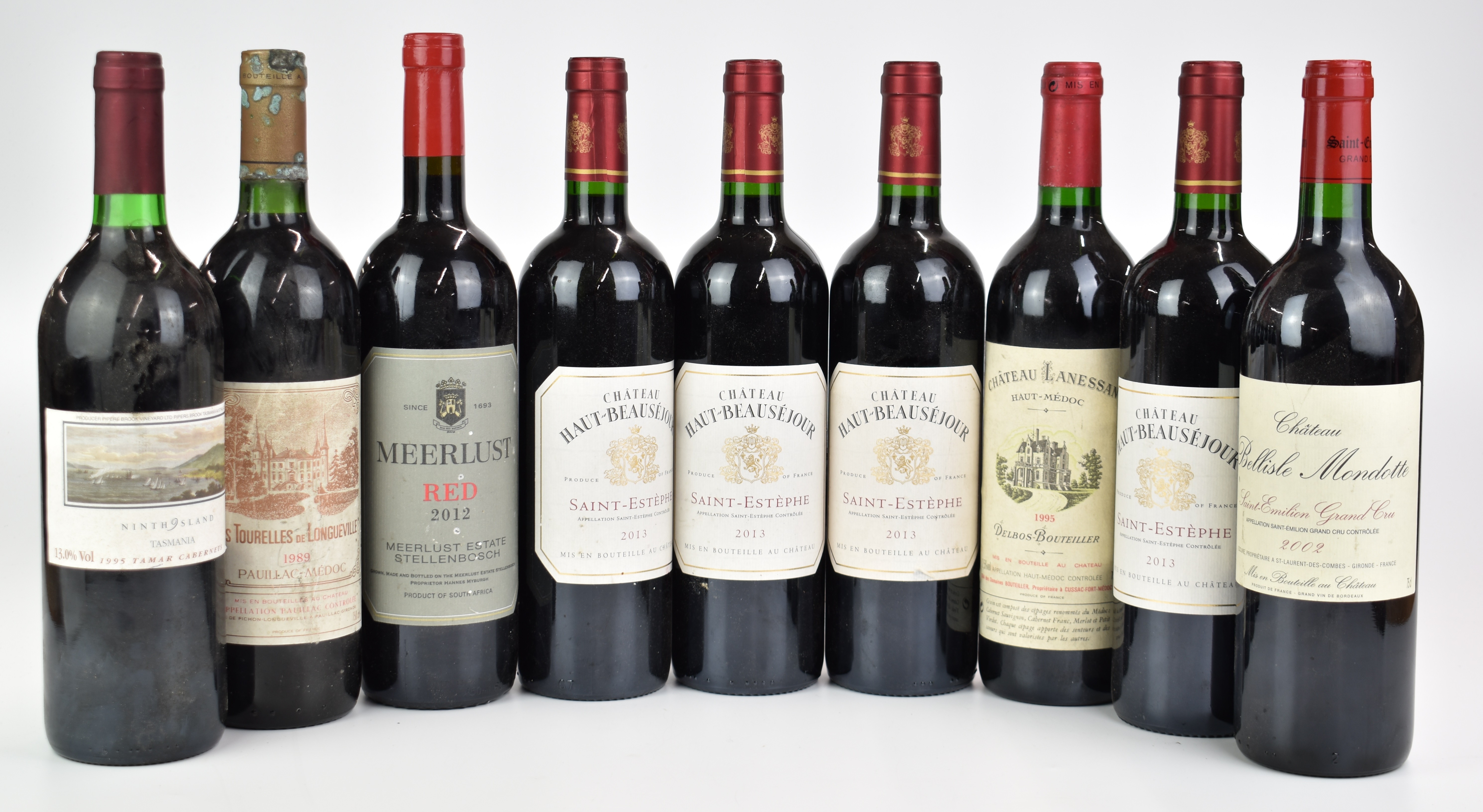 Nine bottles of red wine comprising four Chateau Haut Beauséjour Saint - Estèphe 2013, Chateau Les