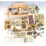 Collection of watch parts and tools including mainsprings, precision measuring devices, vices etc