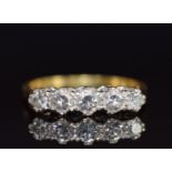 An 18ct gold ring set with five diamonds, the centre diamond approximately 0.18ct, 3.6g, size M