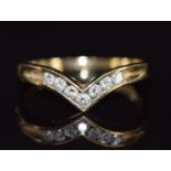 A 9k gold V shaped ring set with seven diamonds, 2.2g, size P