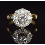 An 18ct gold ring set with diamonds in a cluster, the centre diamond approximately 0.52ct, 5.5g,