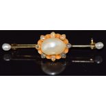 A 14ct gold brooch set with three natural pearls, the largest 7.6 x 11.2mm, and rose cut diamonds,