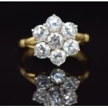 An 18ct gold ring set with seven diamonds, each approximately 0.3ct in a cluster, 4.6g, size O
