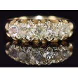 An 18ct gold ring set with five old mine cut diamonds, the centre diamond approximately 0.35ct, 3.
