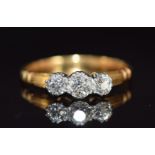 An 18ct gold ring set with three old cut diamonds, the centre diamond approximately 0.35ct, 2.8g,