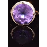 An 18ct gold ring set with a synthetic purple sapphire, 4.4g, size O