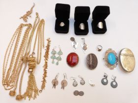 A collection of costume jewellery including silver coin rings, silver ring set with tiger's eye,