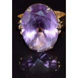 A 14k gold ring set with a synthetic purple sapphire, 7.3g, size L