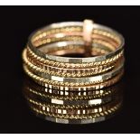 A 9ct gold tri-coloured ring made up of seven faceted and rope twist bands, 3.5g, size M/N