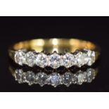 An 18ct gold ring set with seven round brilliant cut diamonds, total diamond weight 0.57ct, with