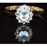 A 9ct gold ring set with aquamarine surrounded by diamonds (missing two diamonds), 1.6g, size M