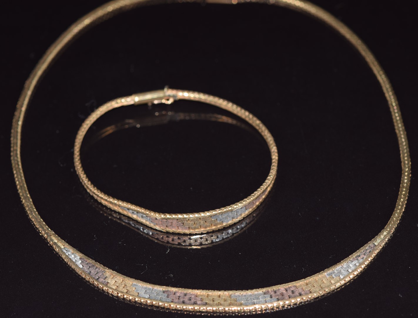 A 9ct gold tri-coloured necklace and bracelet, 24.7g
