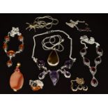 Nine silver necklaces/ pendants set with pressed amber, amethyts, agate, quartz and garnets