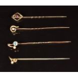 Three 9ct gold stick pins set with zircon, seed pearls and garnet (2.7g) and one other