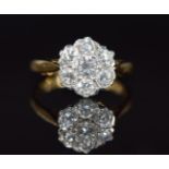 An 18ct gold ring set with seven diamonds in a cluster, the centre diamond approximately 0.25ct, 3.