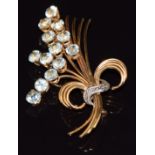 An 18k gold brooch in the form of a stylised bouquet of flowers set with aquamarines, 13.3g