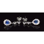 A pair of 18ct gold earrings each set with a pear cut sapphire of approximately 0.45ct surrounded by