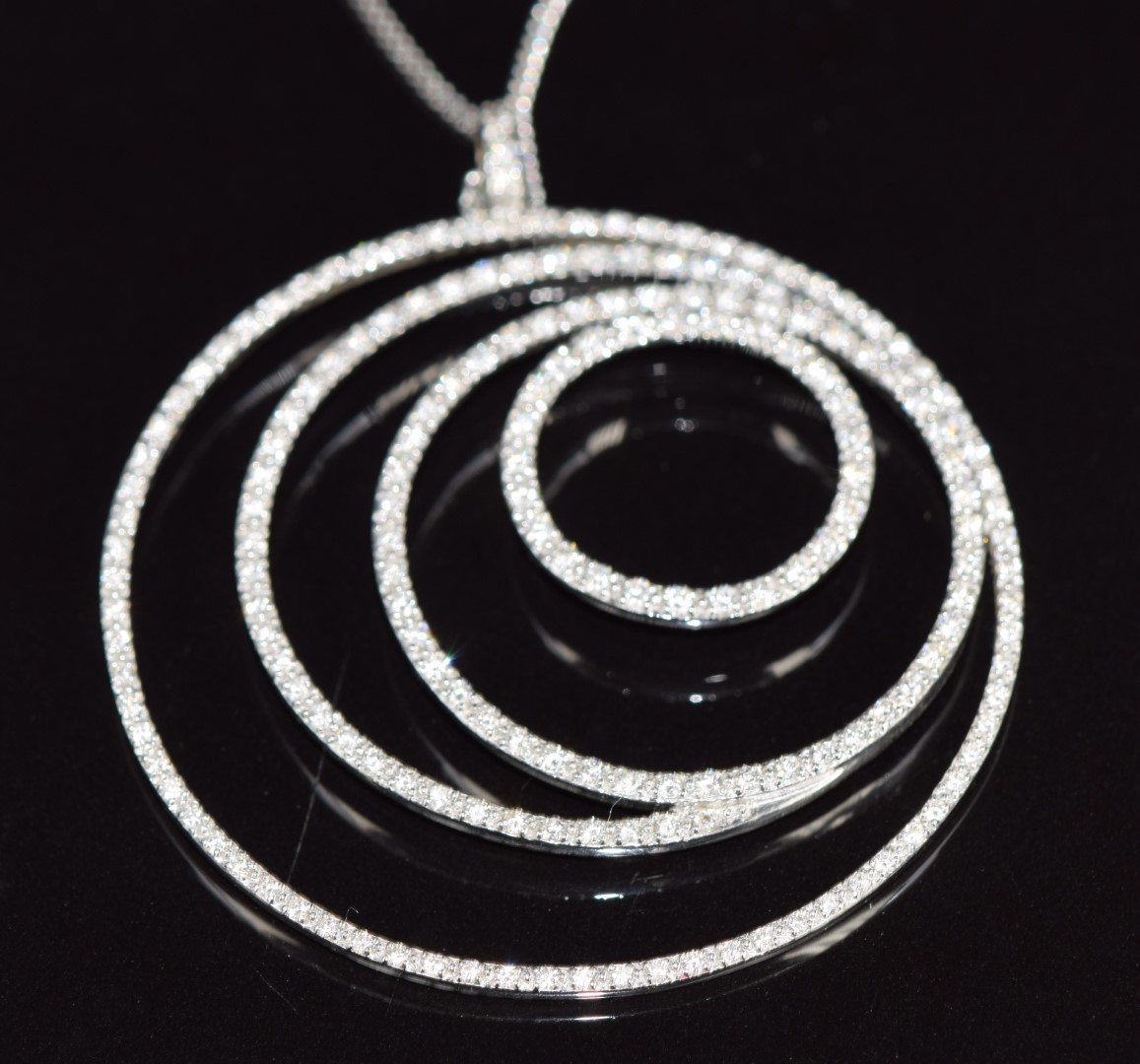 An 18ct white gold concentric circle pendant set with diamonds, on a silver chain, 16.2g - Image 2 of 2