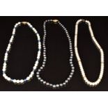 A grey pearl necklace with 18ct gold clasp, cultured pearl necklace with 9ct gold beads, and a