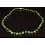 A beaded nephrite jade necklace with 18ct gold clasp and beads