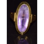 An 18ct gold ring set with an oval cut amethyst, 5.7g, size K