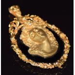 A 9ct gold pendant set with onyx and 9ct gold cameo in relief, and further set with diamonds, 63.7g