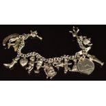 Silver charm bracelet with fourteen charms including horseshoe, monkey, cherub, lion, witch, bear,