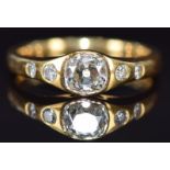 An 18ct gold ring set with an old cut diamond of approximately 0.75ct with further diamonds to the