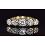 An 18ct gold ring set with five diamonds, the centre diamond approximately 0.25ct, 5.3g, size P