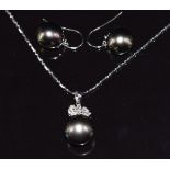 An 18ct white gold pendant set with a 13ct black South Sea pearl, three marquise cut diamonds and
