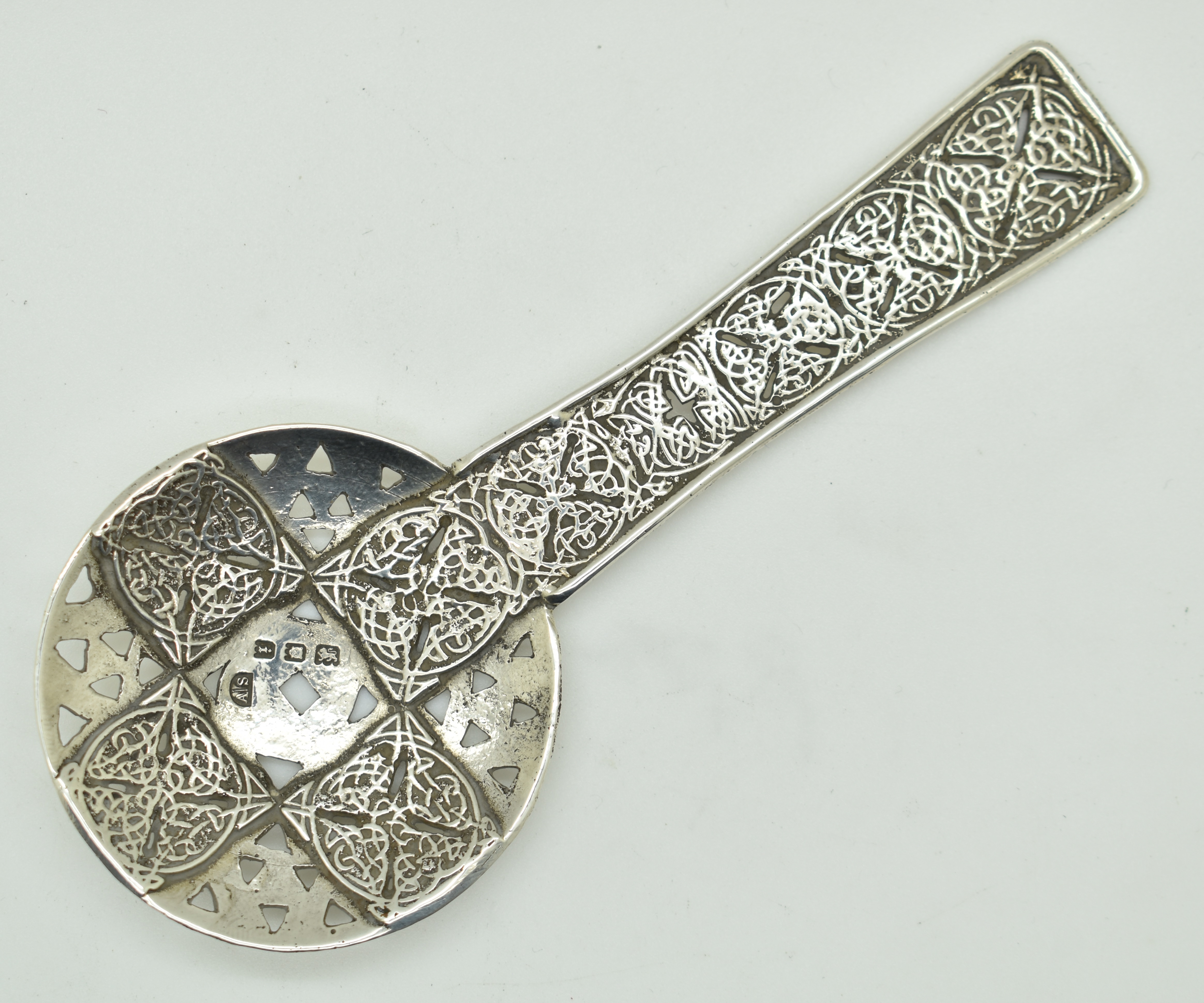 Amy Sandheim Arts & Crafts Celtic style hallmarked silver sifter spoon, London 1924, length 13cm,