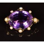 Edwardian 9ct gold brooch set with an oval cut amethyst and split pearls, 9.3g