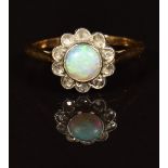 An 18ct gold ring set with an opal surrounded by rose cut diamonds, in vintage box, 2.9g, size M