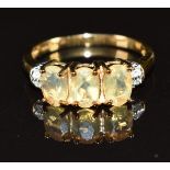 A 9k gold ring set with three oval cut opals and diamonds, 2.6g, size M