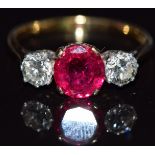 An 18ct gold ring set with an oval cushion cut synthetic ruby approximately 1.6ct and two diamonds