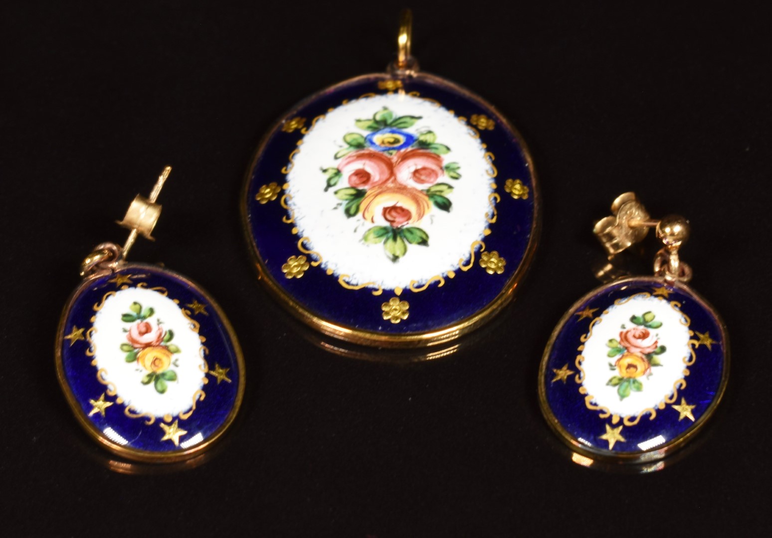 A 9ct gold pendant set with an enamel panel depicting flowers on a blue ground, with matching