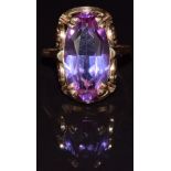 A 14k gold ring set with a synthetic purple sapphire, 8.8g, size Q