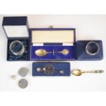 Two cased hallmarked silver napkin rings, two cased hallmarked silver spoons, Russian silver gilt