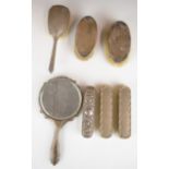 Hallmarked silver backed hand mirror and six various hallmarked silver backed brushes