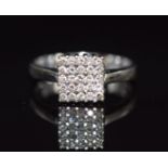 An 18k white gold ring set with diamonds in a square setting, 2.5g, size J