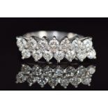An 18ct white gold ring set with fourteen diamonds, each diamond approximately 0.07ct in two rows,