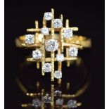 A 1970s 18ct gold ring set with diamonds in a tiered setting the largest diamond approximately 0.